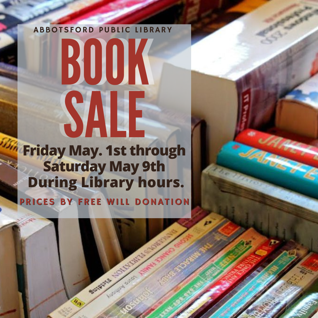 Table with used books on it advertising a book sale.
